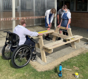 Students use carpentry to make seating for the school